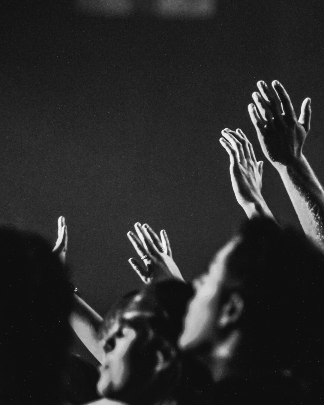 People worshiping with hands raised